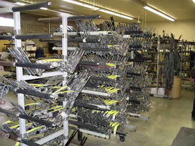 Racks of partially assembled bows - compound risers and limbs